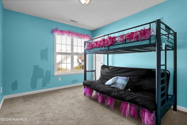 bedroom featuring a textured ceiling and carpet floors