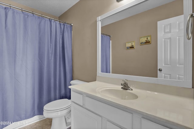 bathroom featuring tile patterned floors, vanity, a textured ceiling, and toilet