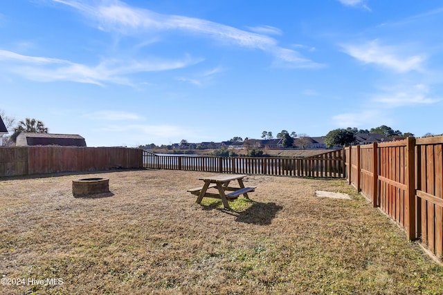 view of yard featuring an outdoor fire pit