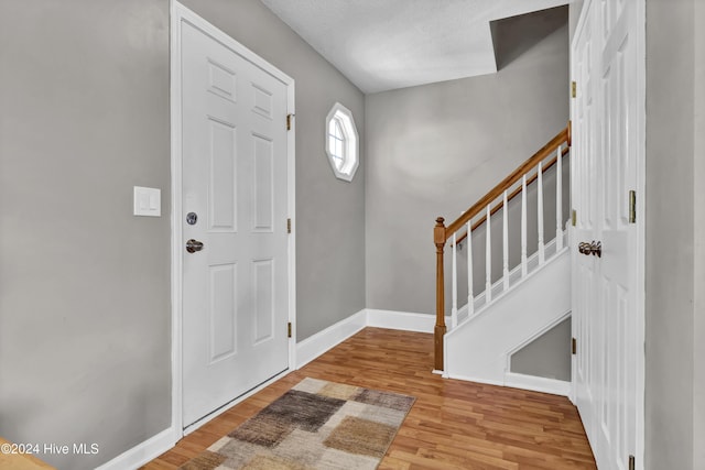 entryway featuring a textured ceiling and light wood-type flooring