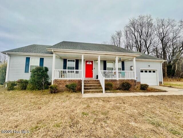 ranch-style home with an attached garage and covered porch