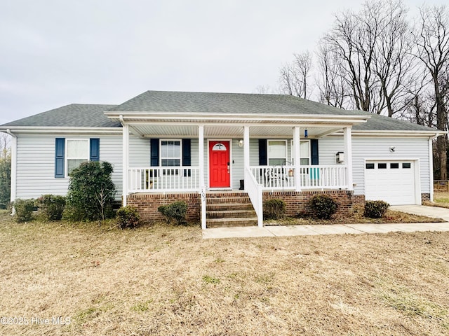 view of front of home featuring a garage, a front yard, and a porch