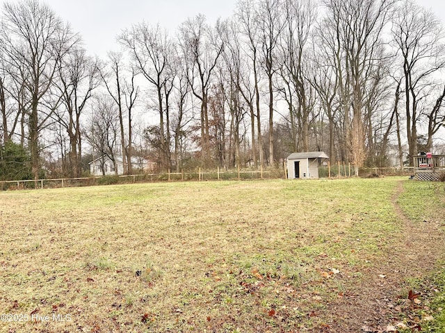 view of yard featuring a storage unit, an outdoor structure, and a fenced backyard