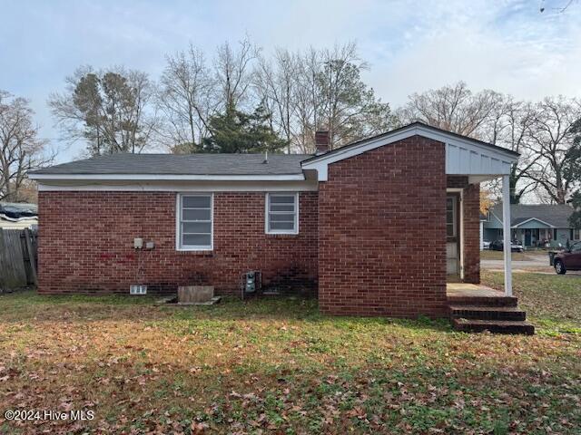 rear view of house with a yard