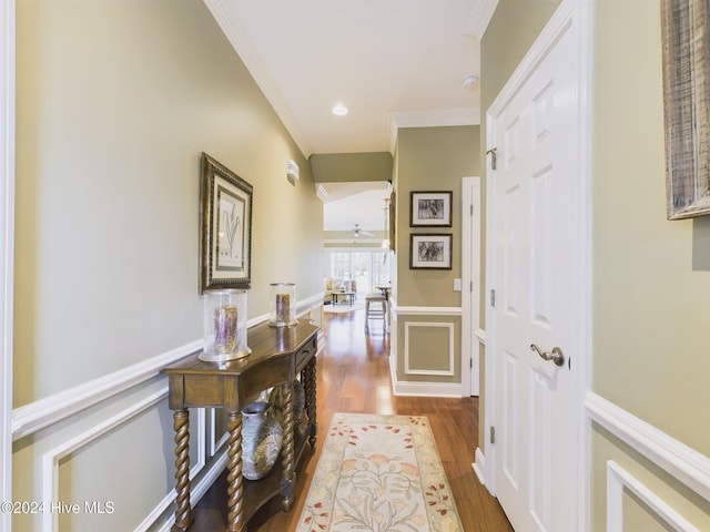 hall with hardwood / wood-style flooring and crown molding