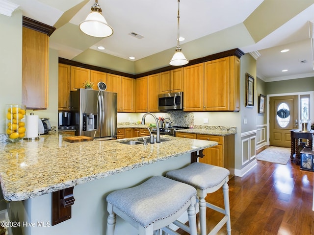 kitchen with dark hardwood / wood-style flooring, stainless steel appliances, crown molding, sink, and decorative light fixtures