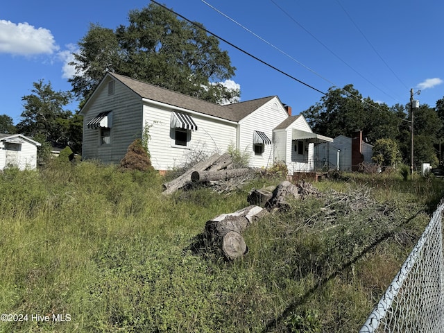 117 Smith St, Rockingham, NC 28379 - view of home's exterior with a shingled roof