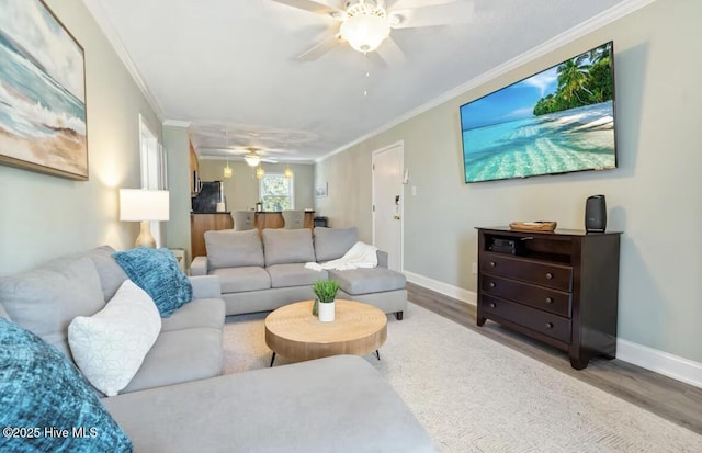 living room featuring ornamental molding, hardwood / wood-style floors, and ceiling fan