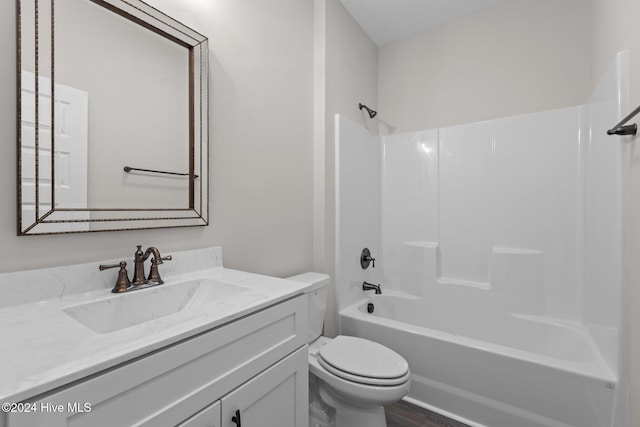 full bathroom featuring hardwood / wood-style floors, vanity, shower / bathtub combination, and toilet