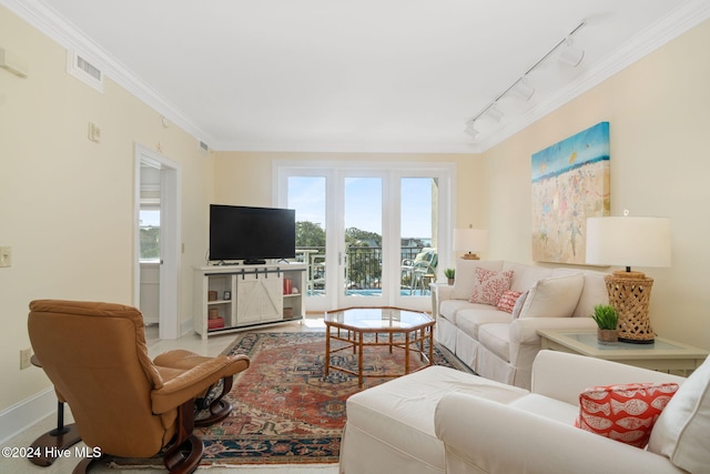 living room featuring rail lighting and ornamental molding