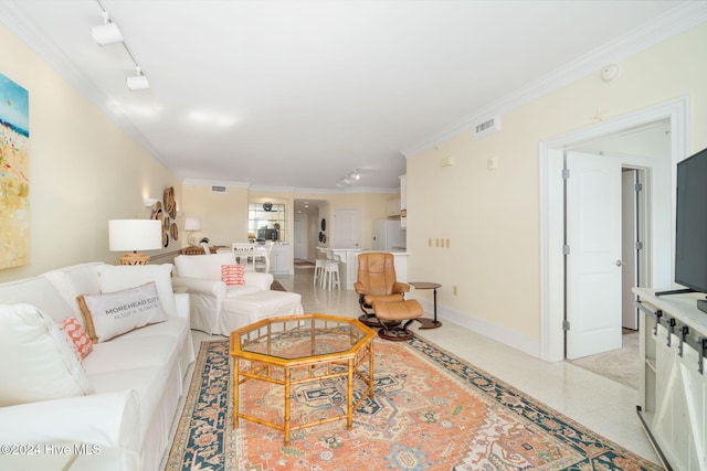 living room with track lighting and crown molding