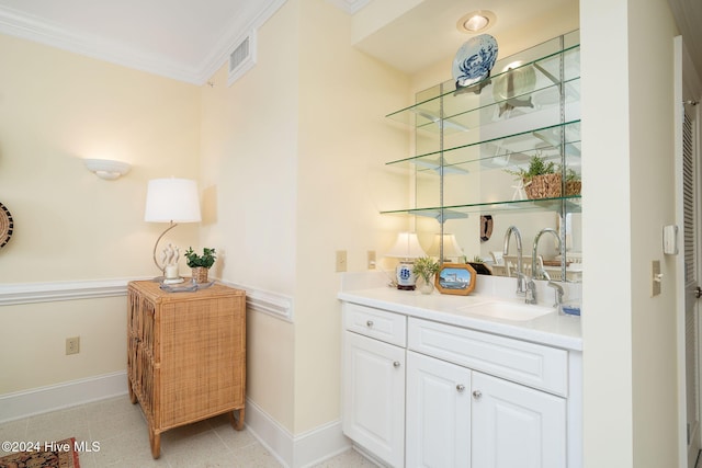 bar featuring white cabinets, ornamental molding, and sink