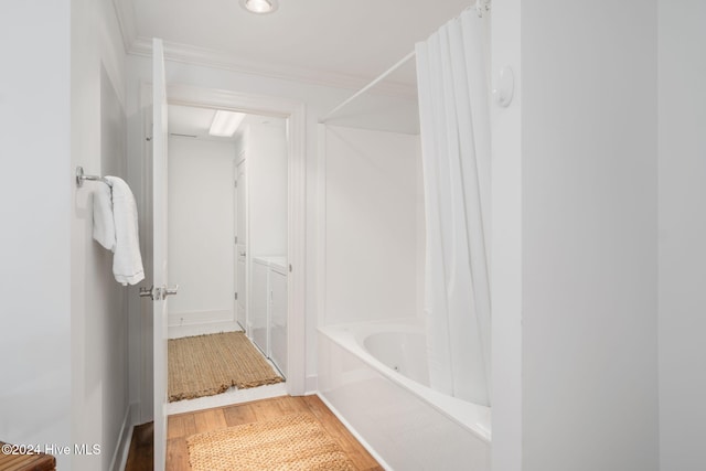 bathroom featuring ornamental molding and hardwood / wood-style flooring