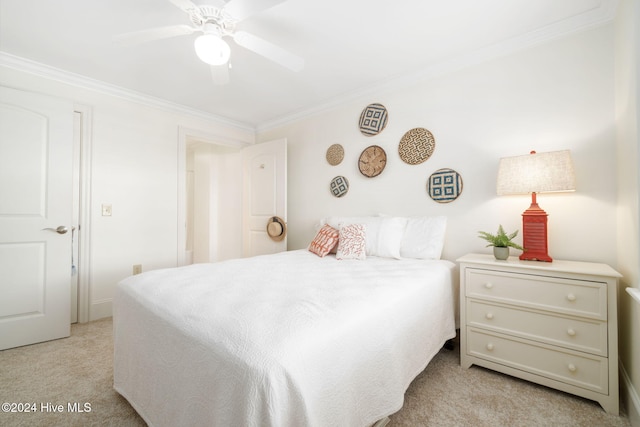 carpeted bedroom with ceiling fan and crown molding