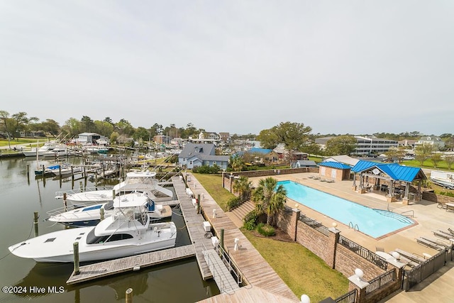 exterior space with a water view, a patio, and a boat dock