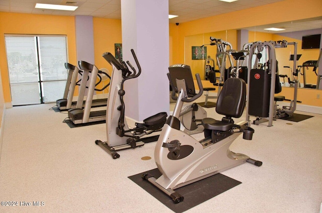 gym with a paneled ceiling