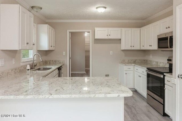 kitchen featuring sink, stainless steel appliances, light hardwood / wood-style floors, white cabinets, and ornamental molding