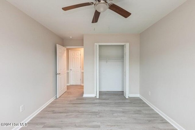 unfurnished bedroom with ceiling fan, a closet, and light hardwood / wood-style floors