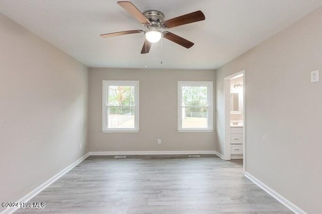 spare room with light hardwood / wood-style floors and ceiling fan