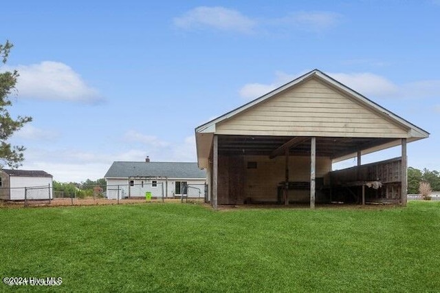 exterior space with a yard and a carport