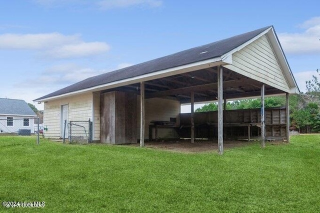 view of outbuilding featuring a lawn