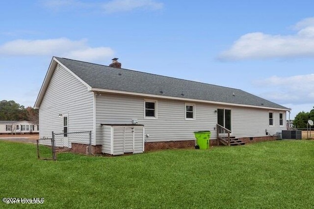 back of house featuring a lawn and cooling unit