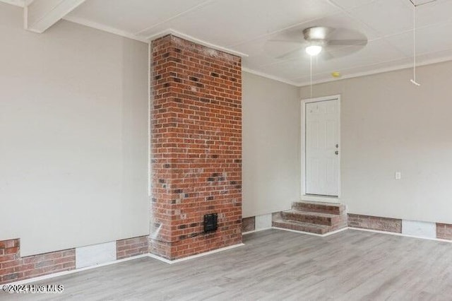 unfurnished living room with hardwood / wood-style flooring, ceiling fan, and crown molding