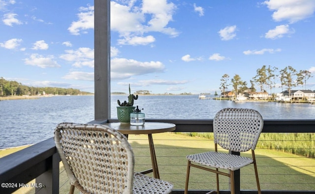 wooden deck featuring a water view