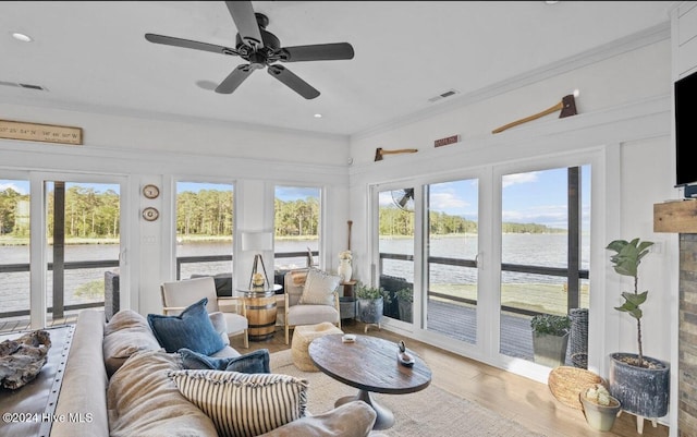 sunroom / solarium with ceiling fan and a healthy amount of sunlight