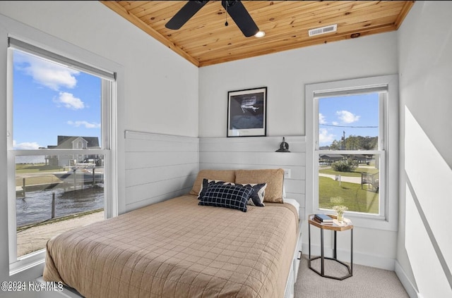 carpeted bedroom featuring ceiling fan and wooden ceiling