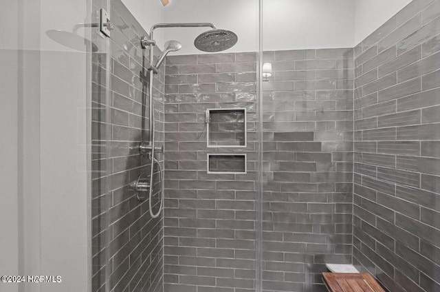 bathroom with a tile shower