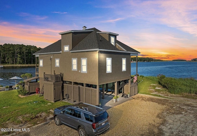 exterior space featuring a water view and a carport