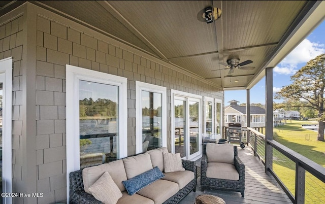 unfurnished sunroom featuring ceiling fan and lofted ceiling