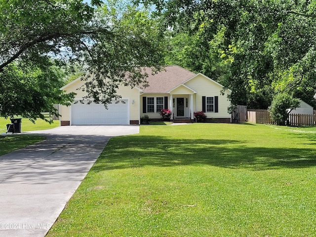 ranch-style house featuring a front yard and a garage