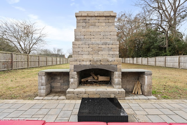 view of patio / terrace with an outdoor stone fireplace