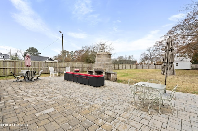 view of patio featuring an outdoor stone fireplace