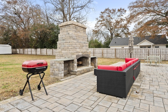 view of patio / terrace featuring an outdoor living space with a fireplace and a grill