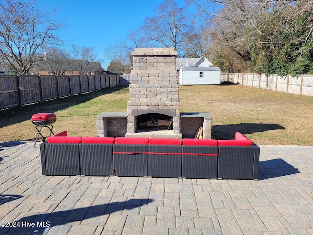 view of patio with an outdoor living space with a fireplace