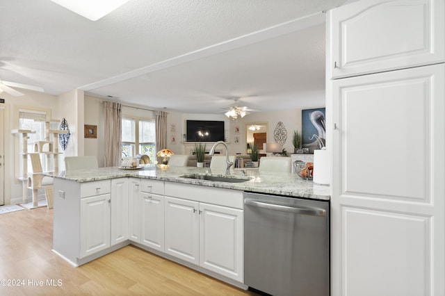 kitchen featuring white cabinets, dishwasher, light hardwood / wood-style floors, and sink