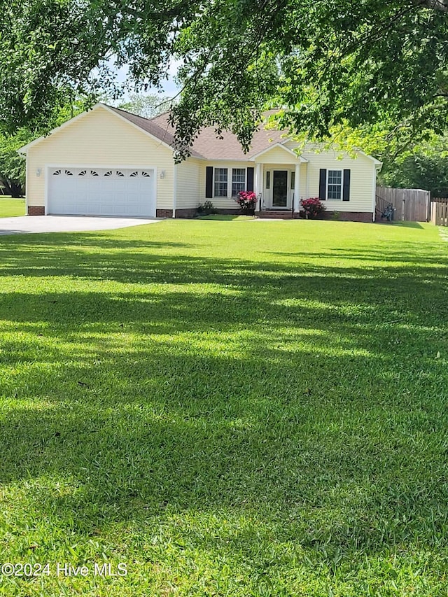 single story home with a garage and a front lawn