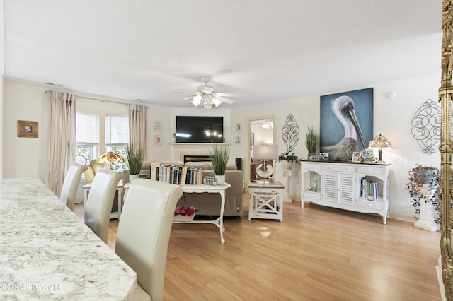 dining area featuring light hardwood / wood-style floors and ceiling fan