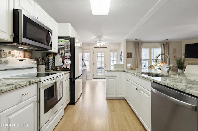 kitchen featuring light hardwood / wood-style floors, sink, white cabinetry, and stainless steel appliances