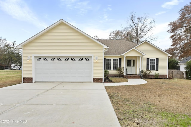 single story home featuring a garage and a front lawn