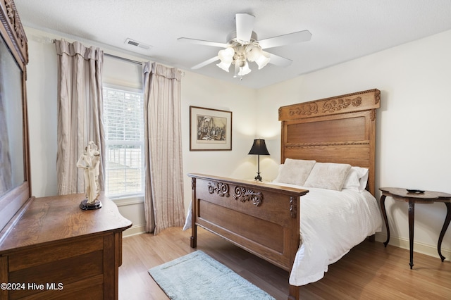 bedroom with ceiling fan and wood-type flooring