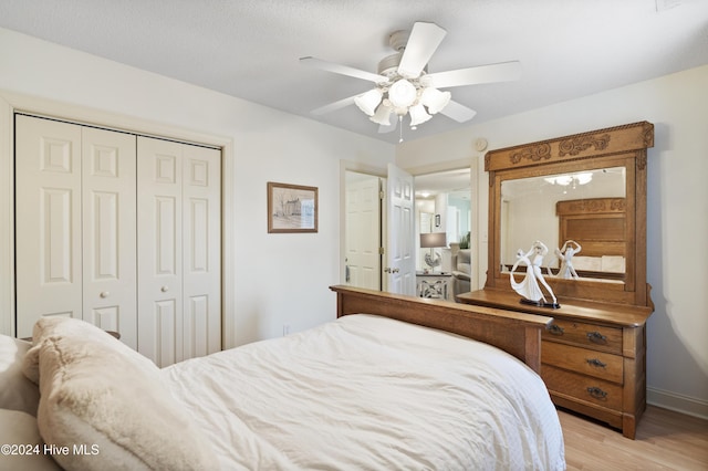 bedroom with ceiling fan, a closet, and light wood-type flooring