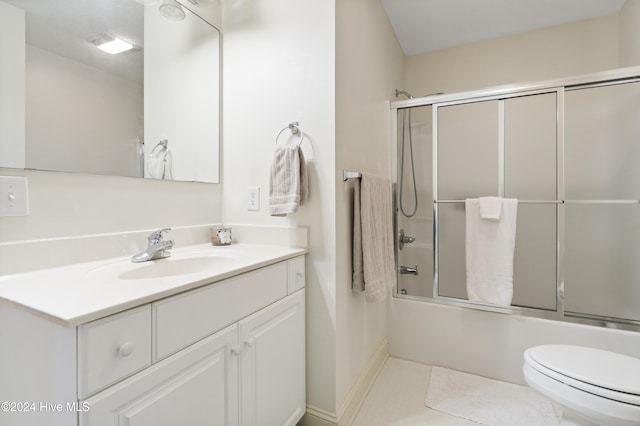 full bathroom featuring tile patterned flooring, vanity, bath / shower combo with glass door, and toilet