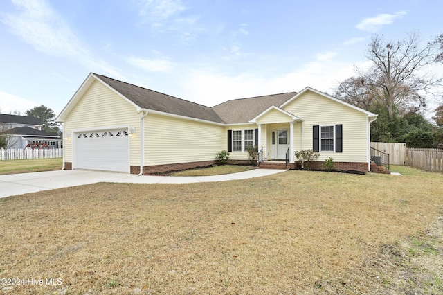 ranch-style home featuring a front lawn and a garage