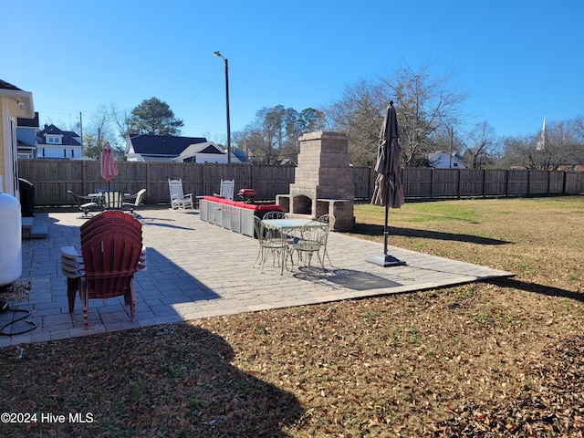 view of patio / terrace featuring exterior fireplace