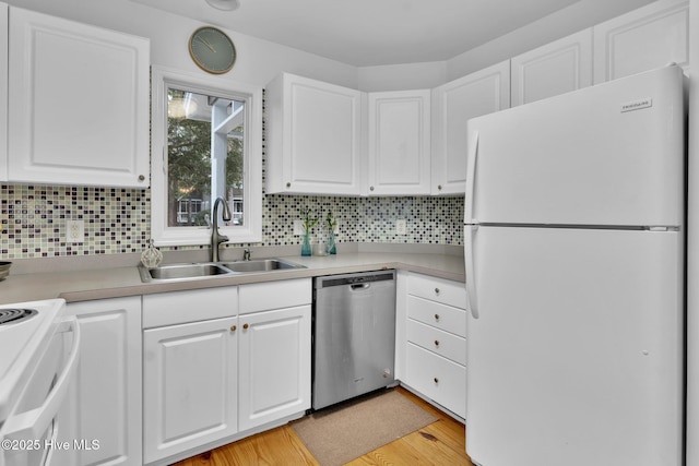 kitchen featuring sink, tasteful backsplash, light hardwood / wood-style floors, white appliances, and white cabinets