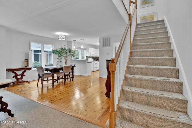 stairs with hardwood / wood-style floors